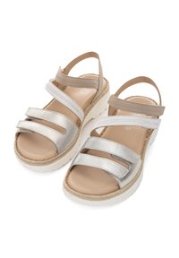 Silver metallic sandals with three wide straps and a beige ankle strap. Textured upper, cushioned footbed, and thick white platform sole.