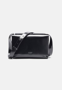 Black, glossy, rectangular handbag with a detachable shoulder strap and silver hardware. Features a smooth texture and embossed logo.