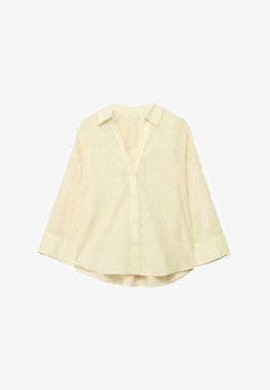 Krémovo sfarbená blúzka s dlhým rukávom, s golierom, zapínaním na gombíky vpredu a mierne zaobleným lemom, zobrazená na bielom pozadí.