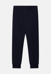 Marineblaue Jogginghose aus weichem Material, mit einem elastischen Bund und elastischen Bündchen für eine bequeme Passform.