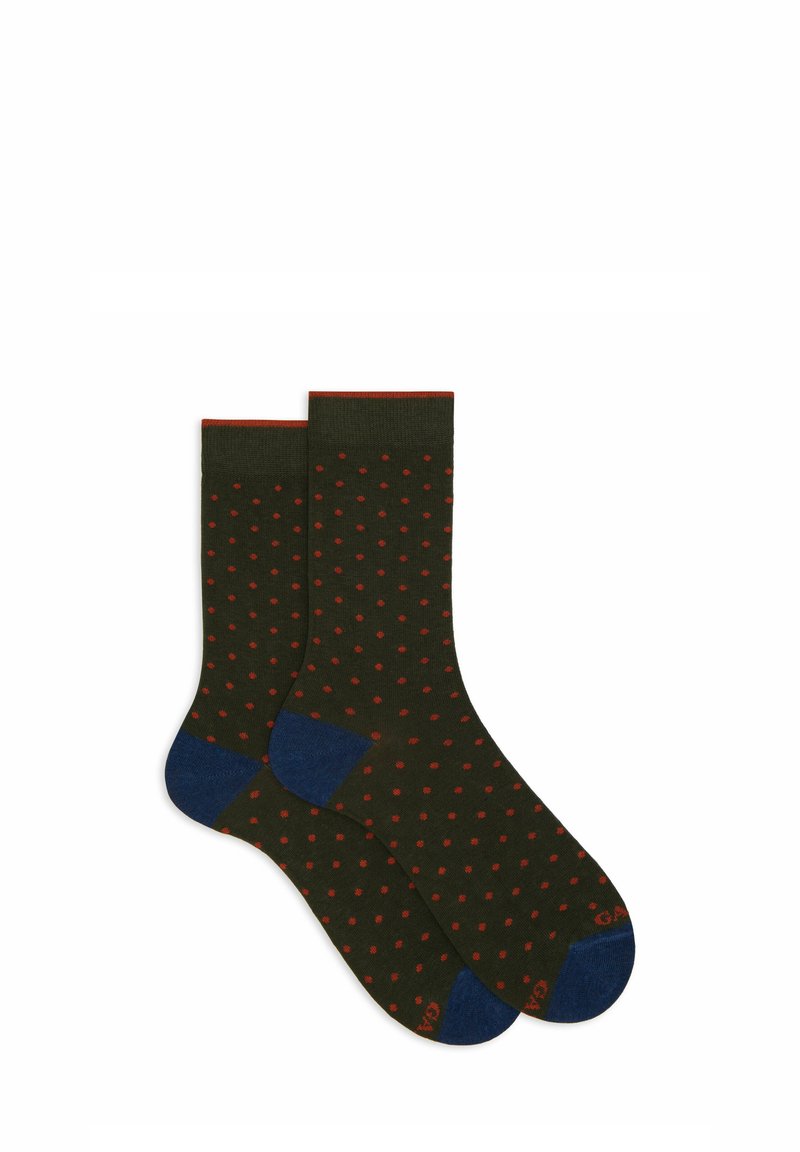 Dark green socks with red polka dots, ribbed cuff, and blue accents at the heel and toe. Made from a soft, stretchy material.