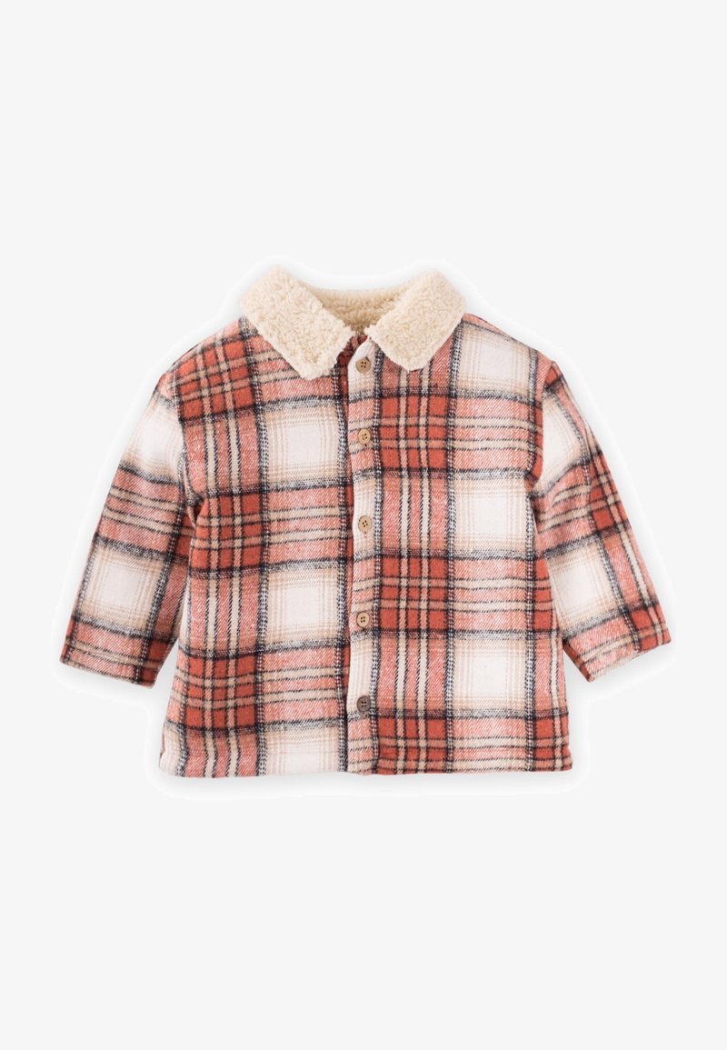 Rūtainā flanelēna krekls oranžā un krēmkrāsā, ar mīkstu krēms krāsas apkakli un koka pogām, ar garām piedurknēm un brīvi plūstošu piegriezumu.