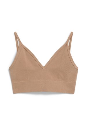 Beige bh met een v-hals, geribbelde textuur en twee verstelbare bandjes. Heeft een brede onderband en subtiele reliëfdetails.