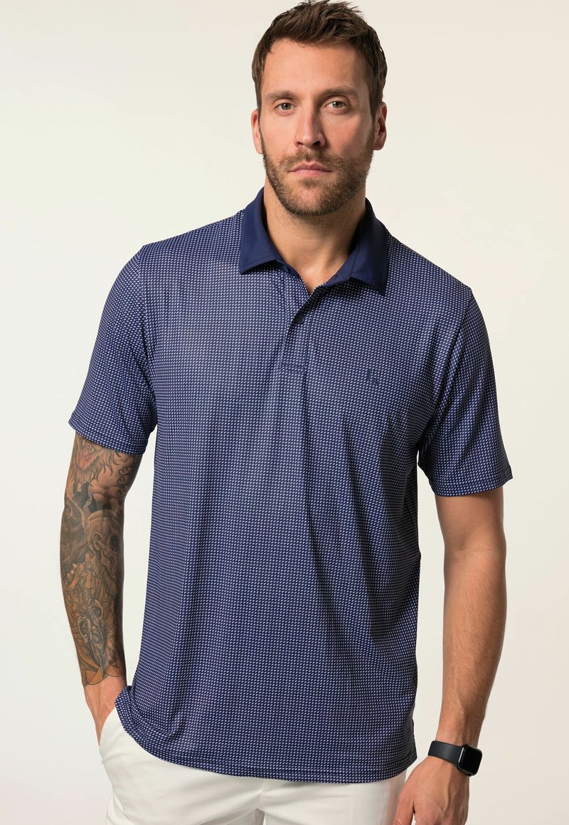 Námořnické polo tričko s texturovaným mřížkovým vzorem, krátkými rukávy a tmavým límcem. Obsahuje logo na hrudi a boční rozparky pro pohodlí.