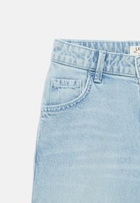 Ανοιχτό μπλε τζιν σορτς με ψηλή μέση, που διαθέτει μπροστινή τσέπη, ορατές ραφές και υφή στην επιφάνεια. Ετικέτα στη μέση.