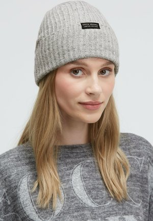 Gray knitted beanie with ribbed texture and a black label reading "SOCYX ORIGINAL LIMITED EDITION." Soft, close-fitting design.
