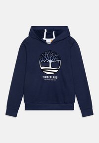Marinblå hoodie i bomull, med en känguruficka. Framsidan har en stor trälogotyp och texten "TIMBERLAND" i vitt.