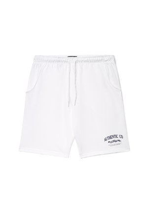 Shorts bianchi in cotone con vita elastica, coulisse e tasche laterali. Presentano un logo blu navy "AUTHENTIC CO" sul lato inferiore sinistro.