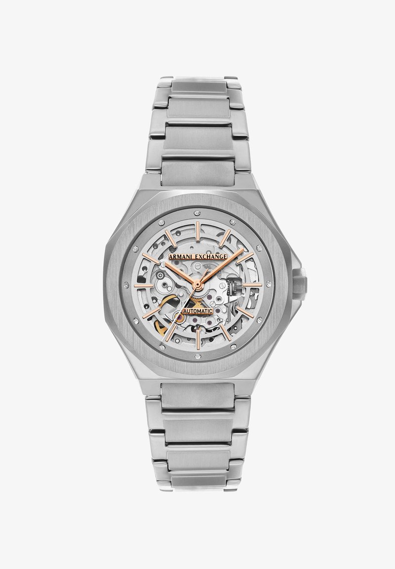 Hopeansävyinen Armani Exchange automaattirannekello, jossa on luurankotaulu, kultaiset yksityiskohdat ja metallinen linkkiranneke.