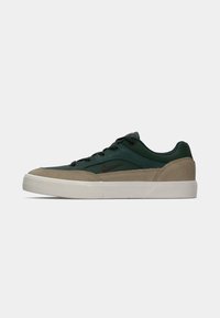 Sneakers with a green and tan suede and textile upper, white rubber sole, featuring a dark red logo, round laces, and padded collar.