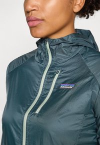 Patagonia HOUDINI - Vodoodporna jakna - cascade green