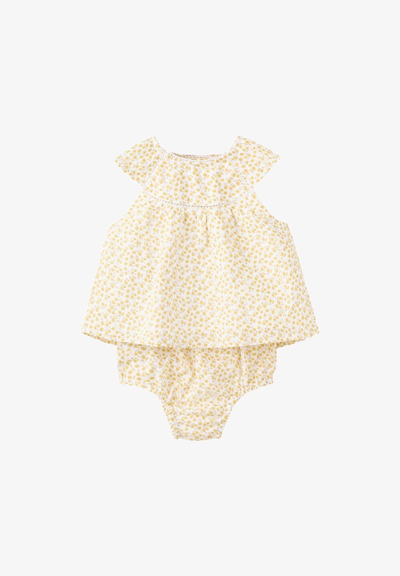Combinaison sans manches pour bébé jaune à motif floral avec un haut ample et un bas froncé sur fond blanc.