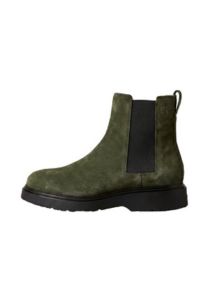Green suede Chelsea boot with black elastic side panel, black sole, and pull tab at back, shown in side profile.