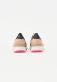Sneakers con una toma in suede e pelle beige e nera, dotati di una suola in gomma rosa e dettagli, forma arrotondata e tallone rinforzato.