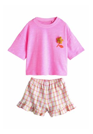 Pink short-sleeve shirt with a small yellow flower patch and white plaid ruffled shorts with pink and green lines.