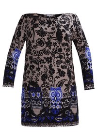 Tunique noire et beige à manches longues, ornée de motifs floraux bleus et de chouettes. Tissu doux avec une coupe décontractée et un col arrondi.