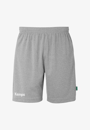 Grijze sportbroekjes van zacht materiaal, met een elastische tailleband en een wit "Kempa" logo aan de linkerkant.