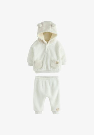 Dwuczęściowy zestaw z polaru w kolorze off-white, z kapturem z uszami misia, kieszeniami na bluzie oraz elastycznym pasem w spodniach.
