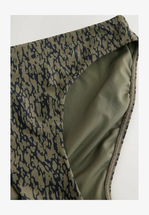 Olivengrønne badetights med et sort abstrakt mønster, glat tekstur og en buet talje, designet til komfort og pasform.