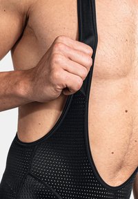 Schwarze Radsport-Bib-Shorts mit strukturiertem Mesh-Design. Verfügt über breite Träger und einen enganliegenden Sitz am Oberkörper.