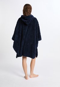 Poncho con cappuccio di un blu navy, realizzato in morbido pile testurizzato, con un design a fantasia e maniche ampie, che arriva a metà coscia.