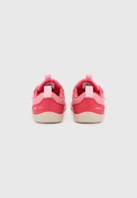 Pink children's shoes with a mesh upper and solid rubber sole. Features heel loops and textured patterns on the sole for grip.