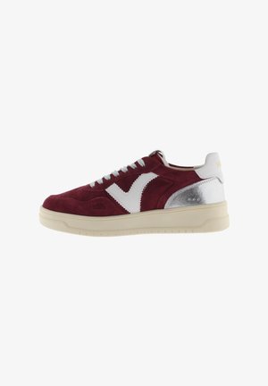 Maroon suede sneaker with white accents, silver heel details, and textured outsole. Features round laces and perforated details on the toe.
