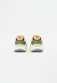 Többszínű mintázattal rendelkező sneaker, bézs, zöld, kék és narancssárga elemekkel; texturált anyagból készült, vastag talppal.