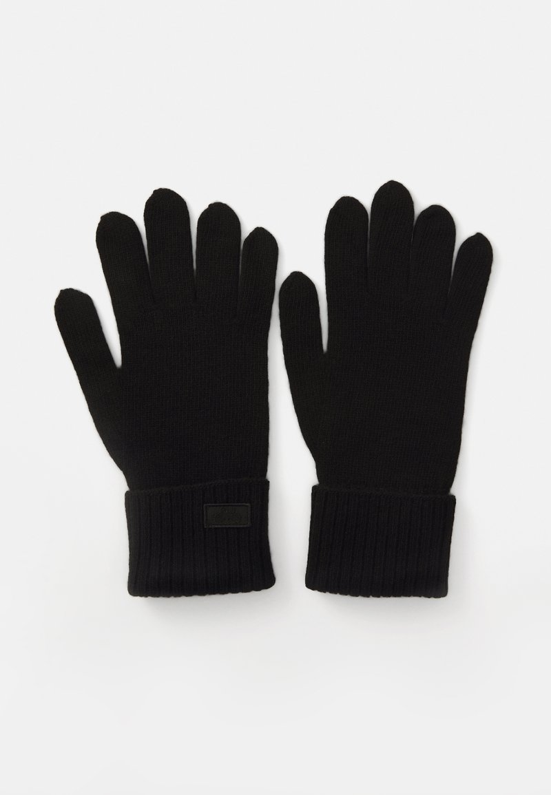 Schwarze Strickhandschuhe mit gerippten Bündchen, aus strukturiertem Stoff mit glatter Oberfläche. Enthalten ein kleines rechteckiges Markenetikett am Bündchen.