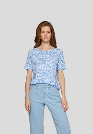 Short-sleeve blue top with a floral pattern, featuring a round neckline and a keyhole detail at the front, paired with light blue trousers.