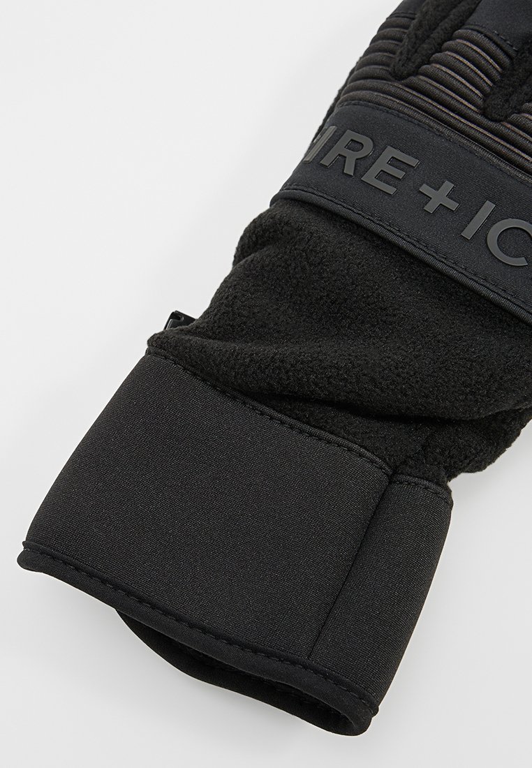 Schwarze Winterhandschuhe mit Fleecefutter, strukturiertem Obermaterial und einem sicheren Wrist-Strap. Materialmischung aus Synthetik und weichem Stoff.