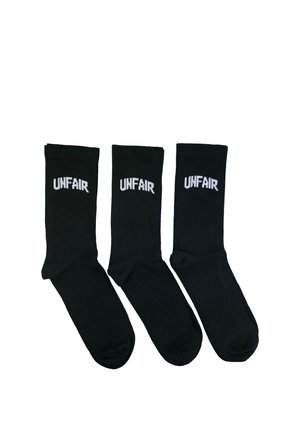 Three pairs of black crew socks side by side, each with the word "UNFAIR" written in white text near the top.