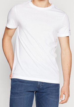 Weißes Baumwoll-T-Shirt mit Rundhalsausschnitt, kurzen Ärmeln und geradem Saum. Minimalistisches Design ohne sichtbare Muster oder Grafiken.