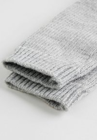 Gray knitted socks with a ribbed texture, folded at the top, showcasing a soft and cozy appearance. Material appears warm and durable.