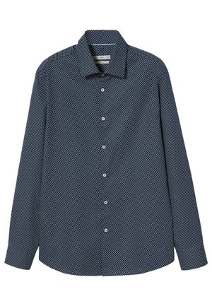 Camicia a maniche lunghe blu navy con bottoni, motivo a pois geometrici bianchi e colletto classico, posata piatta su sfondo bianco.