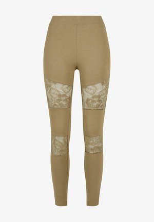 Beige leggings gemaakt van rekbaar materiaal, met doorschijnende kanten panelen op de knieën. Gladde textuur met een getailleerd silhouet.