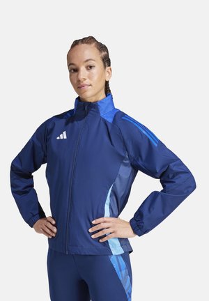 Navy windbreaker jacket with light blue accents, full zipper, high collar, and elastic cuffs. Features three stripes logo on chest.