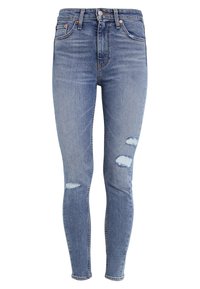 Jeans pitillo de mezclilla azul claro con desgastes rasgados en las rodillas, diseño de cinco bolsillos, trabillas para cinturón y cierre de botones en la cintura.