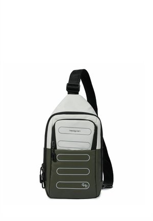 Sac à dos bandoulière bicolore compact en blanc et vert olive avec sangle noire réglable et plusieurs compartiments zippés.