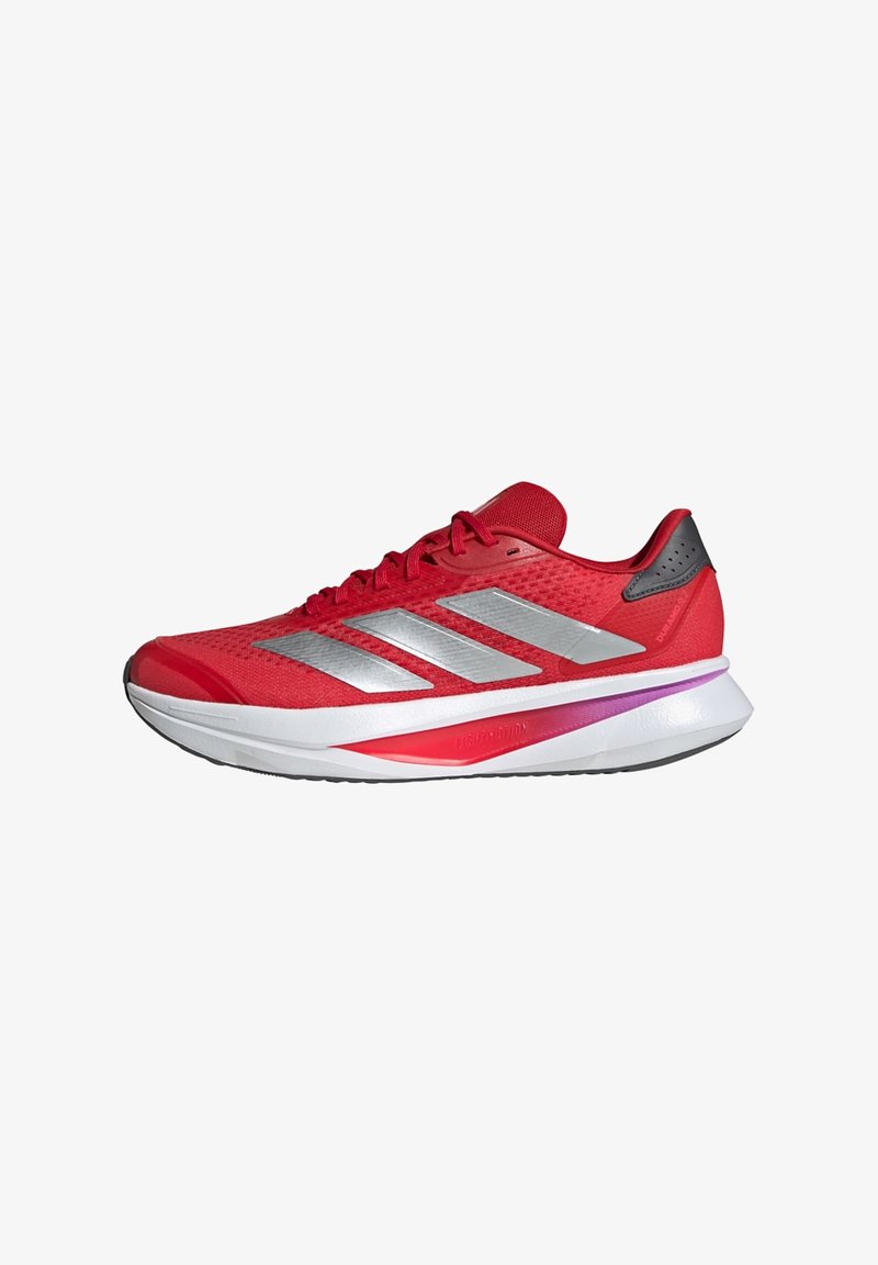 Red athletic shoe with a mesh upper, silver stripes, black accents, and a white foam midsole. Features a slight heel and textured tread.