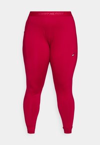 Leggings rouges ajustés, brillants, avec une finition texturée. Présente un logo sur le côté gauche et une ceinture avec marque. Comprend une poche latérale.