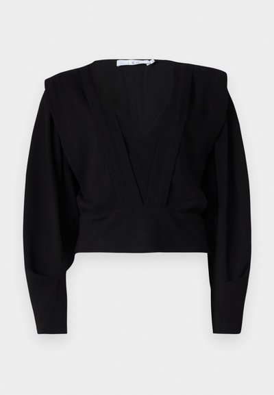 Bluză neagră scurtă cu decolteu adânc în V, mâneci lungi și umeri structurați. Fabricată dintr-un material moale, mata, cu detalii minime.