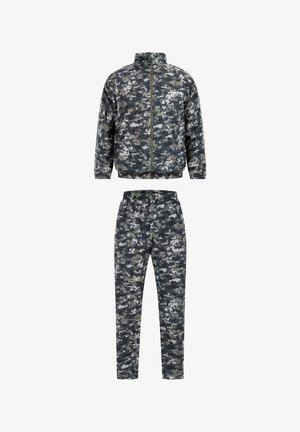 Chándal de patrón de camuflaje en tonos de gris y negro. Cuenta con una chaqueta con cremallera y cuello alto, y pantalones con cinturilla elástica.