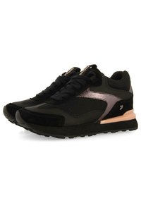 Zapatillas deportivas negras con materiales de malla y ante, que cuentan con acentos metálicos, una suela acolchada y una suela exterior de goma texturizada para mayor tracción.