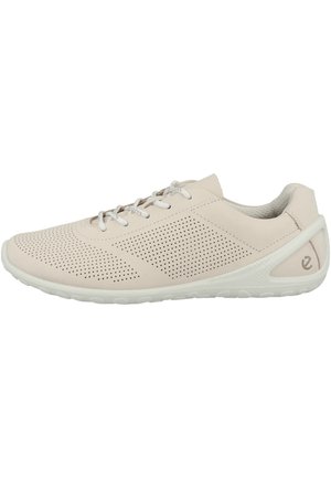 Light beige casual sneaker with perforated upper, white sole, lace-up closure, and small logo near heel on the side.