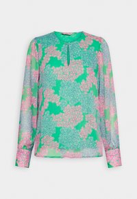 Blusa verde con maniche lunghe, motivo floreale in rosa e blu chiaro, scollatura rotonda con apertura a chiave, realizzata in tessuto leggero e trasparente.