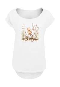 White T-shirt featuring a duck and decorated eggs illustration, surrounded by floral elements. Soft fabric, relaxed fit, scoop neck design.