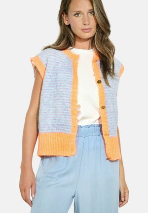 Knit vest in pastel purple and orange with short sleeves, featuring a button front and ribbed edges, worn over a white t-shirt and blue trousers.