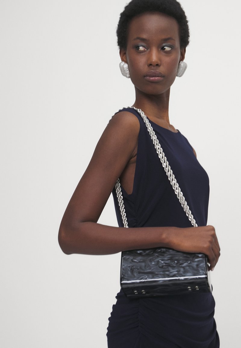 norma kamali sleeveless shirred waist mini dress I Tried the $145 Viral Norma Kamali Pickleball Dress and Fell In Love