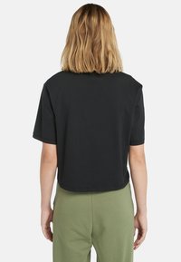 Schwarzes, kurzes T-Shirt mit kurzen Ärmeln, aus weichem Baumwollmaterial gefertigt, mit rundem Ausschnitt und einem schlichten, klaren Design.